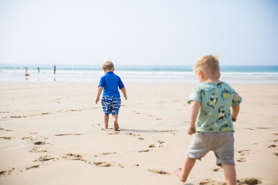 Two children strolling along the beach
